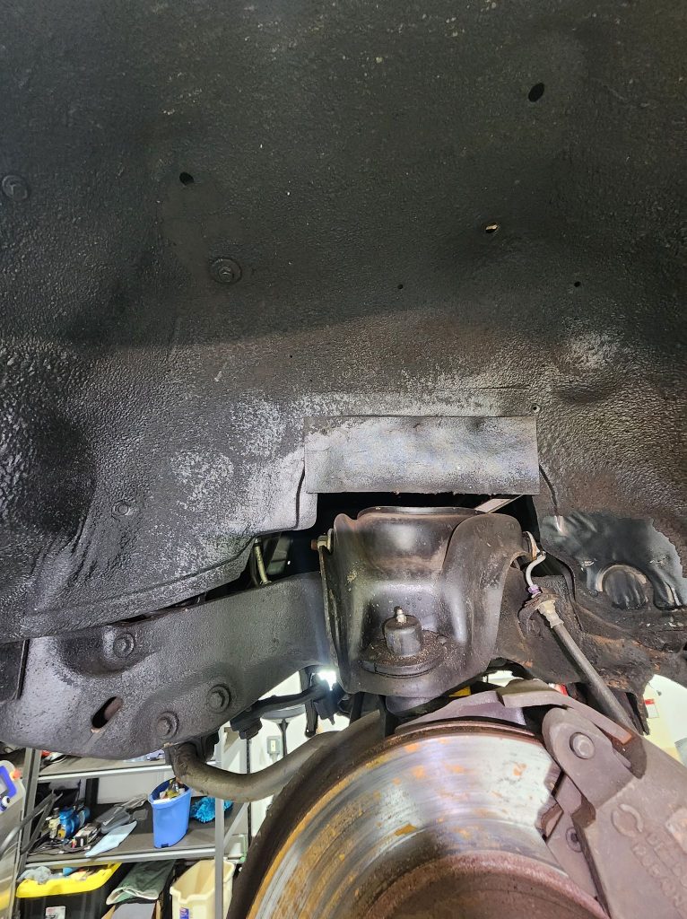 Close-up of car suspension and brake rotor.