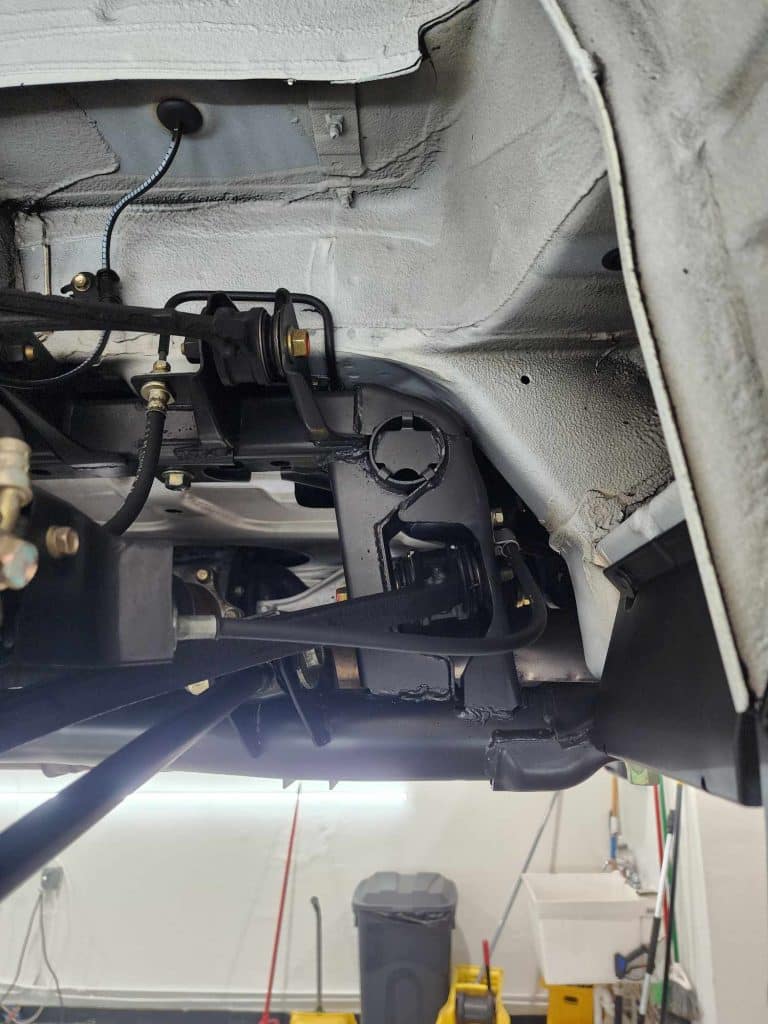 Close-up of vehicle suspension system in garage.